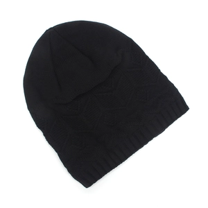 Detailed view of black knitted beanie with geometric diamond pattern and ribbed edge