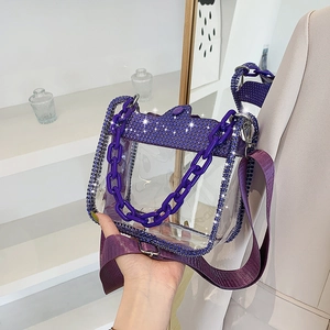 Detailed shot of purple transparent PVC handbag with rhinestones and thick chain handle