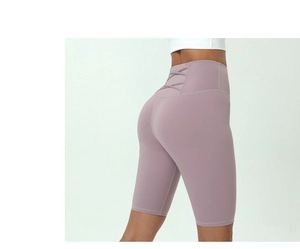 Detail view of mauve high-waisted yoga shorts with stylish criss-cross back straps design