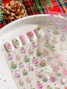 Detail showing 3D embossed gold Christmas tree nail stickers with snowflake patterns