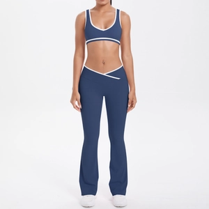 Detail of navy yoga set featuring V-shaped crossover waist and white contrast piping