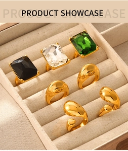 Showcase of seven geometric gold-plated titanium rings with assorted crystals and textures