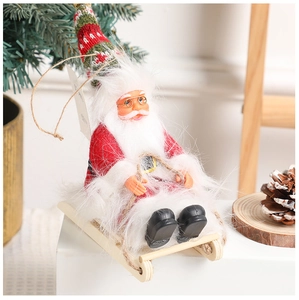Detail of Santa Claus on a wooden sleigh with red knit hat and plush white beard