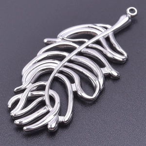 Macro view showing detailed hollow feather texture on a polished silver stainless steel pendant