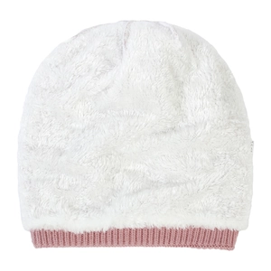 Close-up of white plush winter hat with pink ribbed knit cuff and soft texture detail