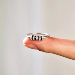 Detailed close-up of s925 silver anxiety ring featuring five rotating zircon beads