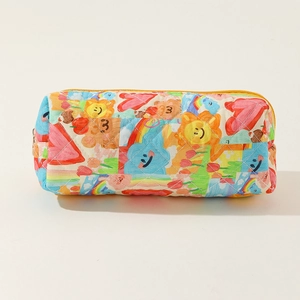 Close-up of quilted floral cotton pouch with colorful patches and yellow zipper detail