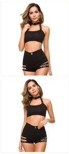 Dettaglio del top all'americana nero e pantaloncini con fibbie laterali su sfondo bianco