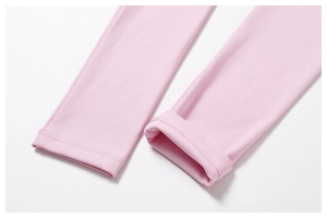 Macro shot of pink yoga leggings cuff showing fine knit texture and flatlock stitching
