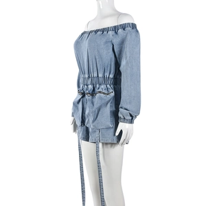 Detail of blue denim romper featuring elastic waist and functional front zip pockets