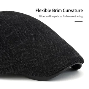 Wool newsboy cap with herringbone pattern and leather brim detail for men