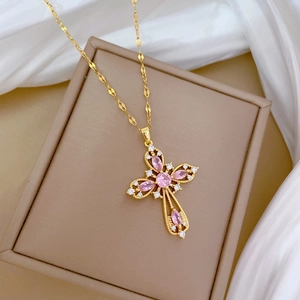Luxurious gold titanium cross necklace with pink gemstones and sparkling crystals