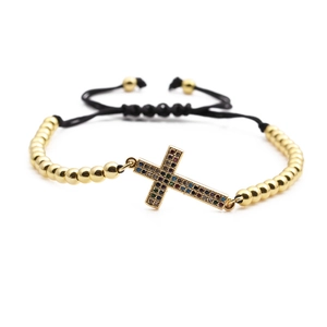 Gold beaded bracelet with colorful zircon cross pendant on black adjustable cord
