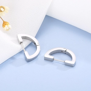 Macro shot of silver D-shape stainless steel earrings with latch back closure detail