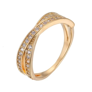 Crossed golden ring design featuring pavé set cubic zirconia on a white background