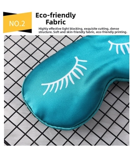 Detail view of teal satin sleep mask featuring white eyelash print on soft silk fabric