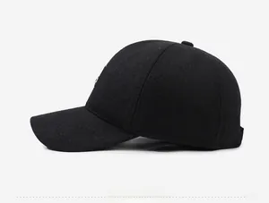 Side view of a warm black wool winter baseball cap with ear flaps and structured design