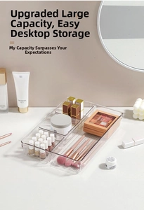 Close-up of a clear acrylic multi-compartment organizer for cosmetics on a desk