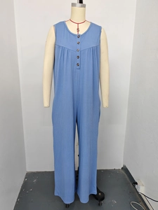 Close-up of sky blue ribbed knit jumpsuit featuring functional brown buttons