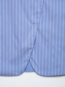 Close-up of blue vertical striped top featuring matching button and fabric texture