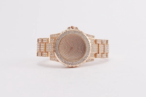 Close-up of luxury rose gold watch fully paved with crystals on band and dial