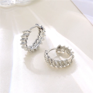 Minimalist silver twisted hoop earrings with textured beaded finish for women