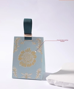 Detail of light blue gift bag with vintage floral patterns and For You metal clip