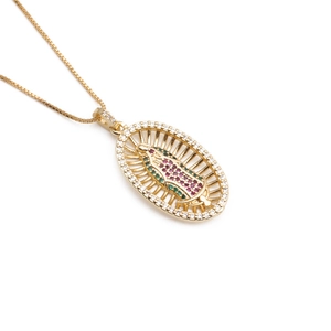 Golden Virgin Mary oval pendant necklace with colorful crystals on white background