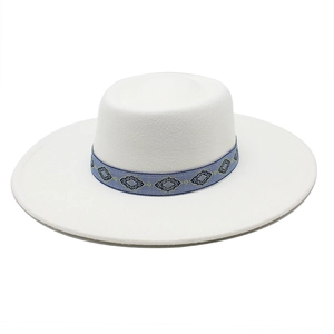 Close-up of white wool felt fedora with a blue ethnic patterned geometric hat band