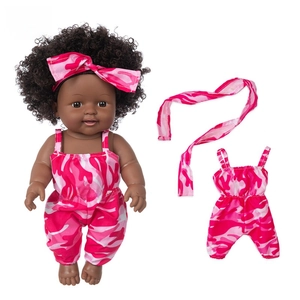 Macro view of realistic 12 inch African baby doll in pink camo romper with bow headband
