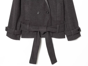 Close-up of the adjustable cuffs and waist tie detail on a dark grey wool coat