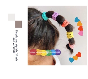 Detail of candy-colored ruffled seamless hair ties for kids in five vibrant shades