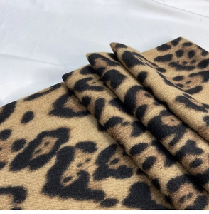 Close-up of thick leopard print scarf showing soft cashmere-like texture and detailed fabric