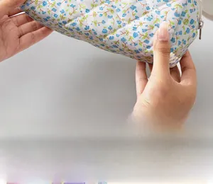 Close-up of diamond quilted floral stationery pouch with secure metal zipper closure