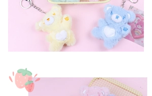 Detailed view of colorful plush teddy bear keychains with heart patterns on pink background