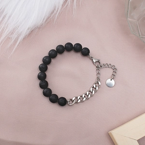 Detail of beaded bracelet with black lava stone and silver Cuban chain for men and women