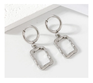 Detail of silver stainless steel geometric earrings with hollow square hammered texture