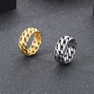 Close-up of punk style Cuban chain link rings in gold and silver stainless steel