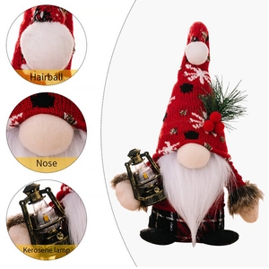 Detail view of gnome showing knitting texture, plush beard, and miniature LED lantern lamp