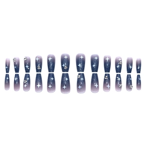Blue-purple gradient press-on nails with white stars and rhinestones on white background