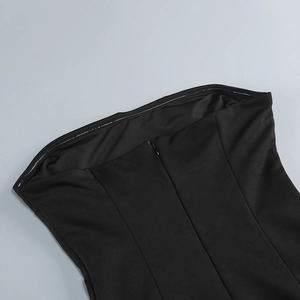 Detail of hidden back zipper and transparent silicone non-slip strip on black strapless dress