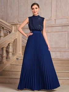Elegant sleeveless navy blue pleated maxi dress with sequined bodice on stone steps