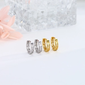 Close-up of gold and silver S925 sterling silver hoop earrings with Greek key hollow design
