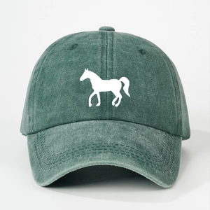 Detailed close-up of dark green washed cotton baseball cap with white horse silhouette print