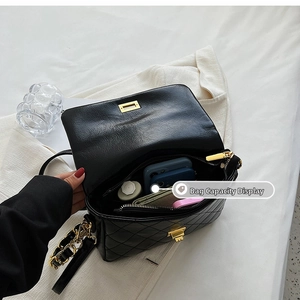 Interior view showing capacity of quilted crossbody bag with daily essentials inside