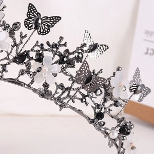 Detailed macro view of dark metal bridal crown with butterfly and flower motifs