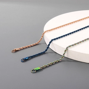 Macro shot of 3mm stainless steel rope chains in rose gold, dark blue, and rainbow finish