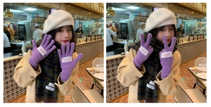 Detail of purple knit gloves with woven label and matching plaid scarf in daily use