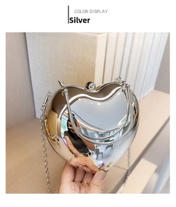 Detail of silver heart-shaped mirror acrylic bag with metal handle and chain strap