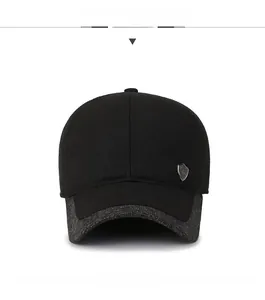 Front view of men's winter baseball cap featuring grey wool brim and side shield badge